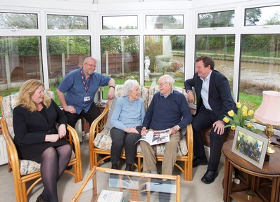 Home Instead co founders with clients and caregiver
