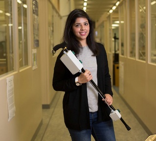Neha Shahid Chaudhry with a prototype of the 'smart' walking stick