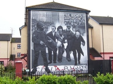 Priest waving a hanky  in Bloody Sunday mural in the Bogside area of Derry