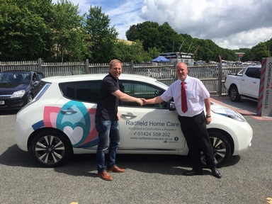 Mr Holmes and his Nissan Leaf/ Credit: Samuel Holmes
