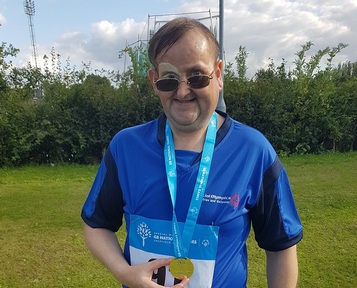 Nigel showing off his Gold medal/ Credit: Danshell Group