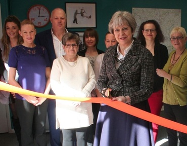 Prime Minister Theresa May cuts the ribbon to officially open Right at Home's 50th home care branch Credit: Right at Home