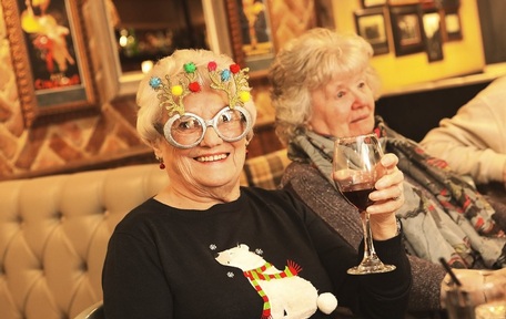 Elderly enjoying a drop of festive cheer at the Christmas party at Kingslodge Inn. Credit: The Abbeyfield Society.