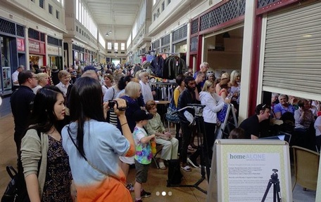 Shoppers gather for 'Home Alone' performance at Newcastle's indoor market. Credit: Sharon Bailey