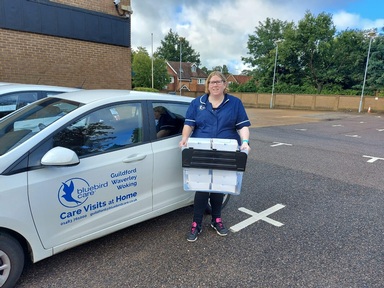 Staff at Bluebird Care distribute the poetry book to home care clients and care workers across Surrey
