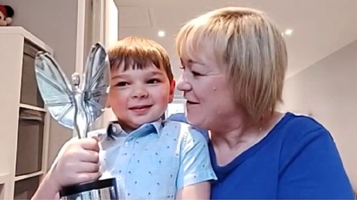 Tony with his mum Julie Hugdell holding his Pride of Britain Good Morning Britain Young Fundraiser Award.