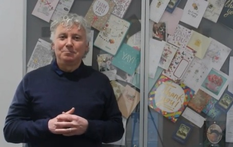 Beloved Homecare managing director Mark Collier stands in front of thank you cards sent by relatives. Credit: Beloved Homecare