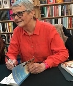 Credit: Wendy Mitchell signing her book about living with dementia.