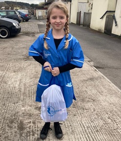 Ellen Kelly on her way to school dressed as her care worker mum for Superhero day. Credit: Sam Kelly