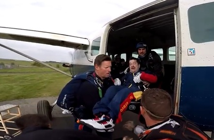 Mark Pike being lifted from his wheelchair into plane.  Credit: Bluebird Care