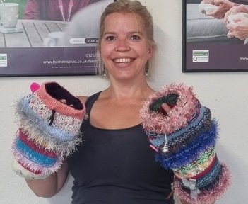 Annie Warner wears twiddle muffs. Credit: Home Instead