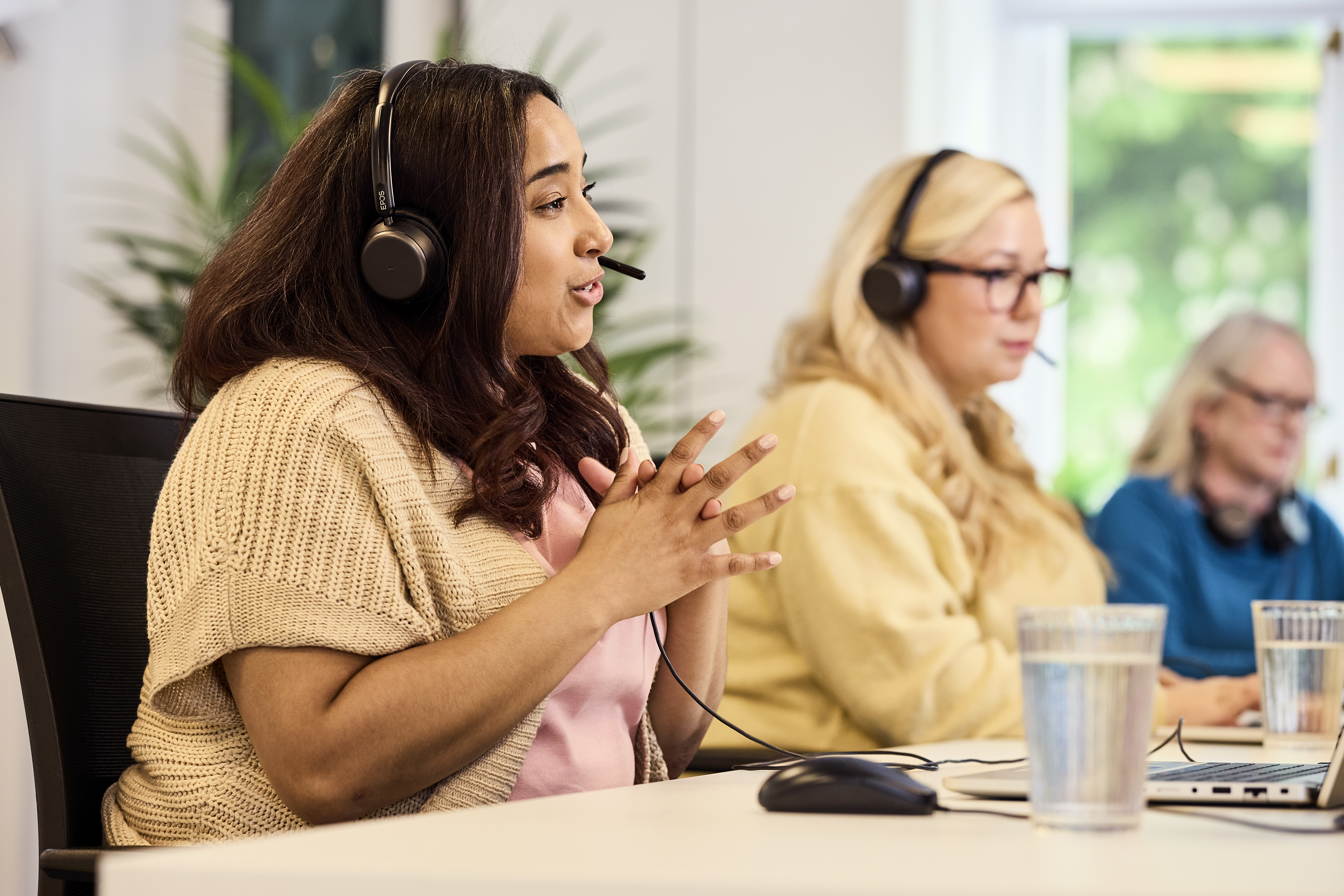 Care Help Team advisor wearing a headset speaking with a family on the home care helpline